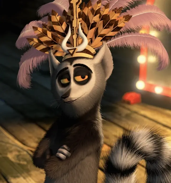 King Julien in a feathered headdress with his arms crossed