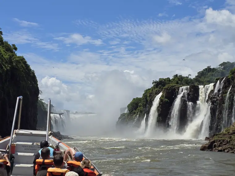 Boat approaching thundering waterfalls