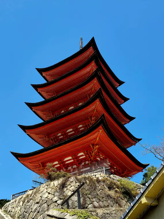 Five story red pagoda against a blue sky